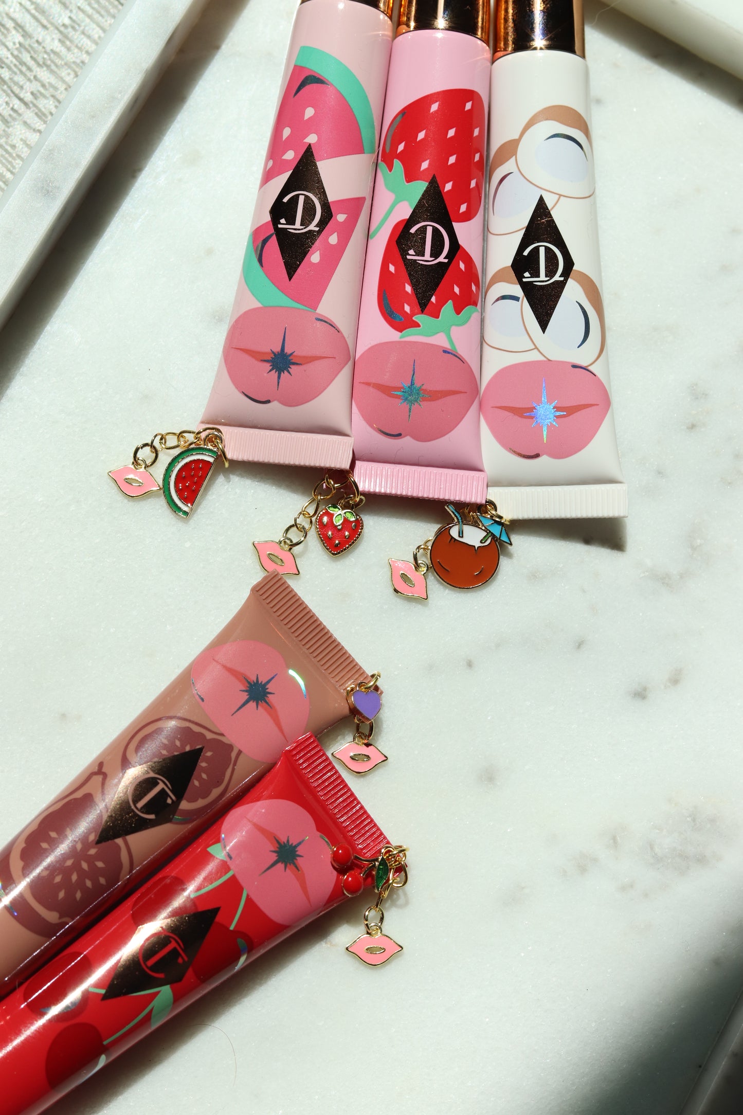 Lip gloss with decorative packaging on a marble surface