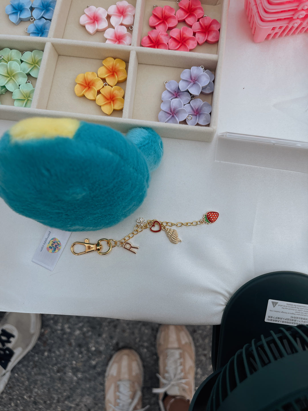Colorful flower-shaped objects and a keychain on a white surface.