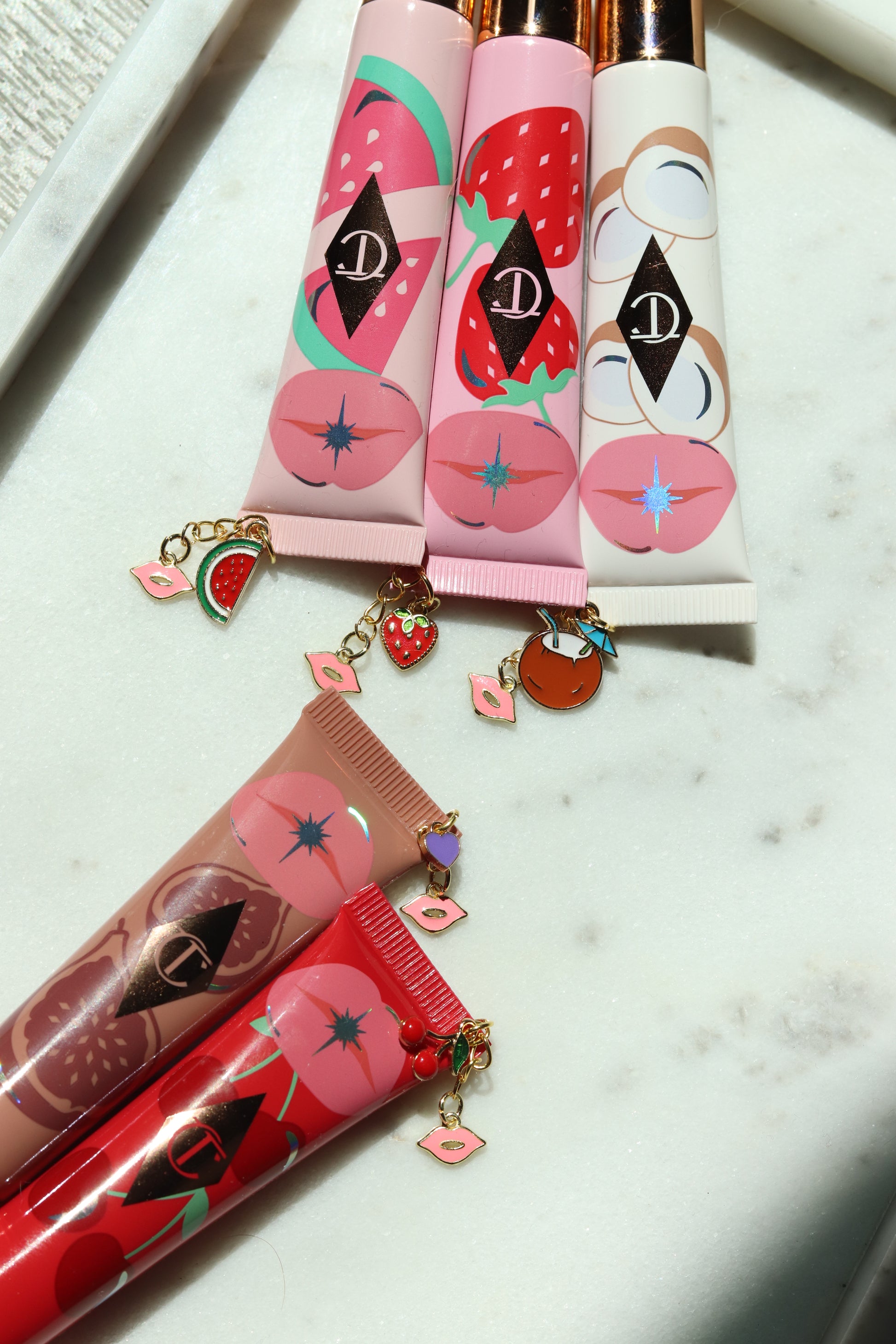 Lip gloss with decorative packaging on a marble surface